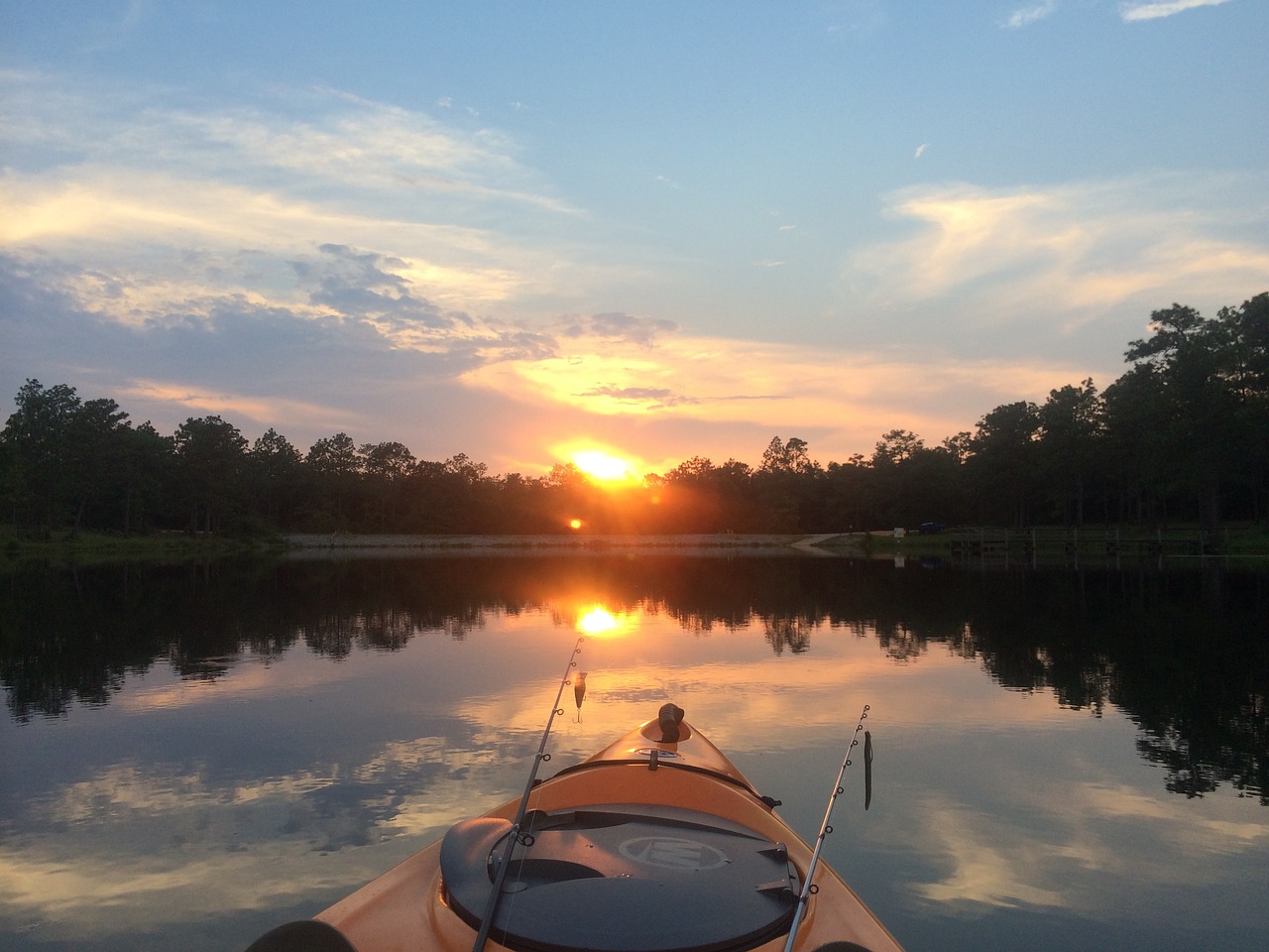 kayak with fishing rods on lake